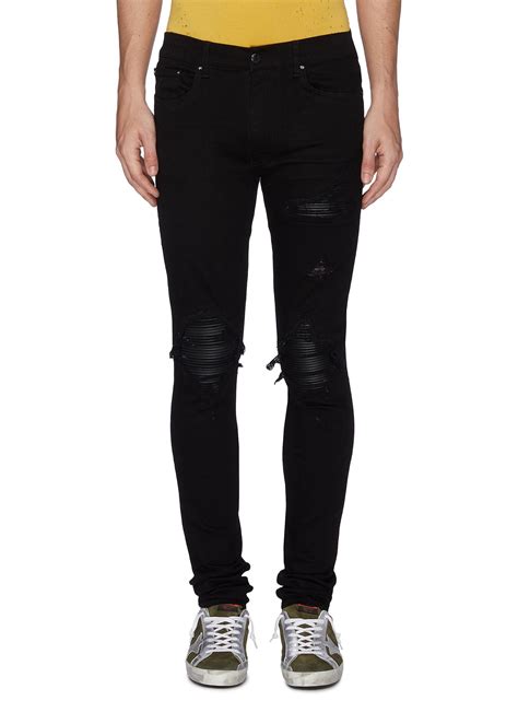 amiri jeans with black patches.